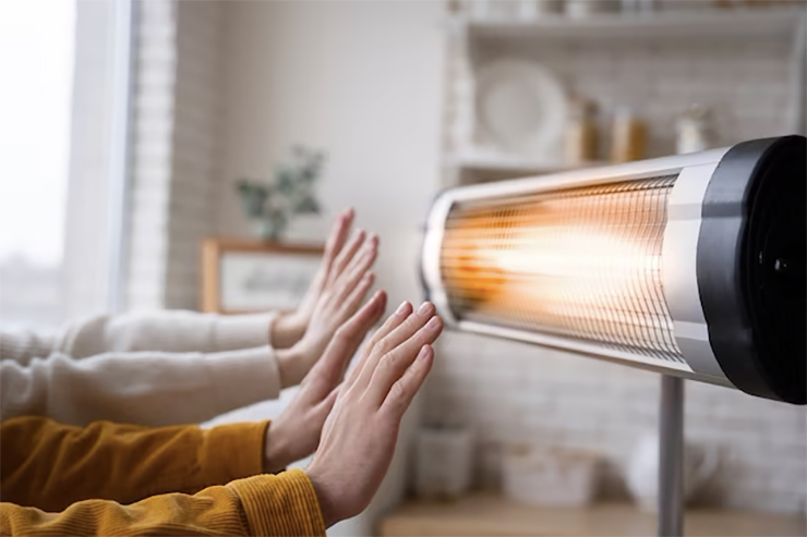 people warming up hands near heater_23 2149339532 copy